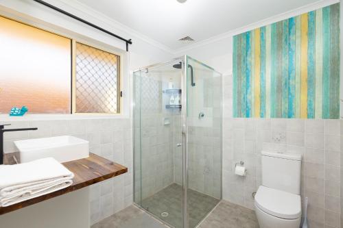a bathroom with a shower and a toilet at Hallett Cove House 6Bed 3Bath Full Kitchen Fast Wifi 5TV Netflix Espresso-Perfect for large families in Halletts Cove