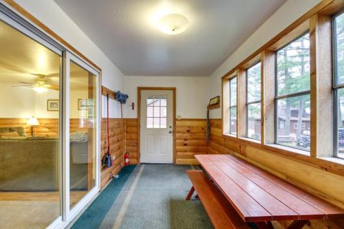 a room with a wooden bench and windows at Lakefront Bemidji Getaway with Community Beach! in Bemidji