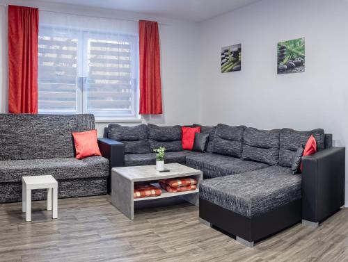 a living room with a couch and a table at Domeček Janov in Janov