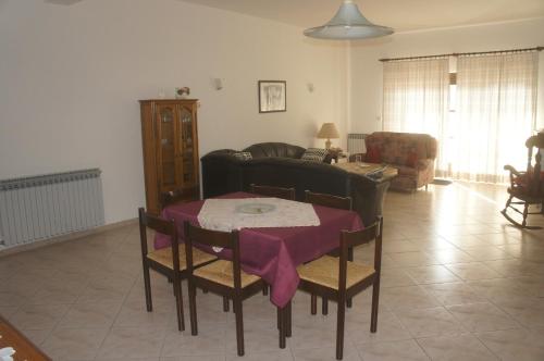 a living room with a table and a couch at Suran Apartments in Pula