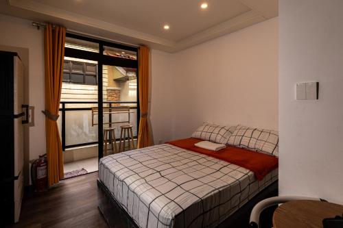 a small bedroom with a bed and a window at Johannes Condo in Baguio Megatower IV in Baguio