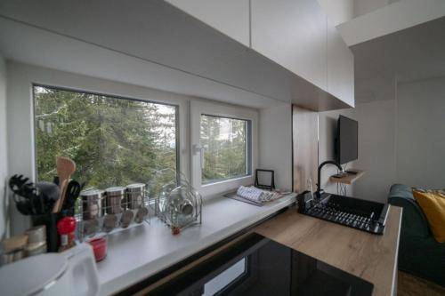 a kitchen with a large window and a counter top at Kuca 59 in Jahorina