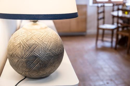 a lamp sitting on top of a white table at Tenuta di Megognano in Poggibonsi