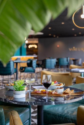 a table with food and wine glasses on it at Holiday Inn - Chicago Dwtn - The Mart by IHG in Chicago