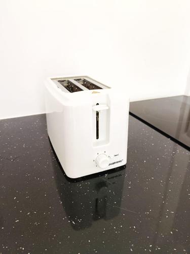 a white toaster sitting on top of a counter at La belle Martinique in Sainte-Luce