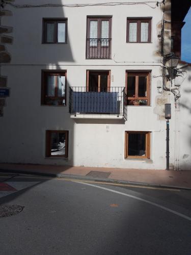 a white building with windows and a balcony at Atalaya in Mundaka