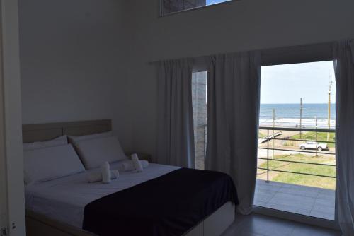a bedroom with a bed and a view of the ocean at Condo Costa Azul in Costa Azul