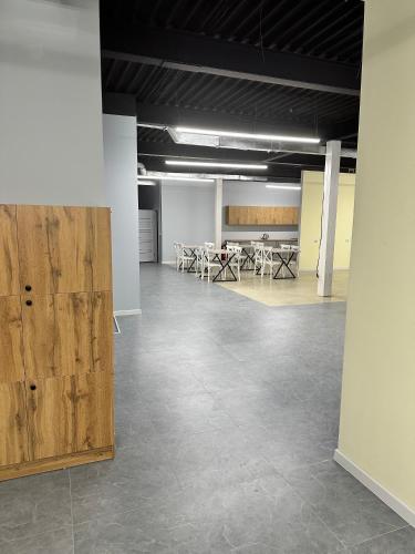 a large room with tables and chairs in it at Hostel O2 in Almaty