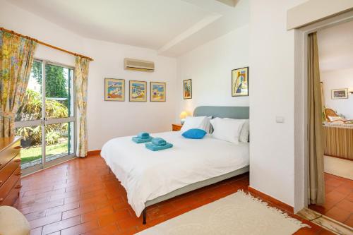 a bedroom with a bed and a window at Villa Quadradinhos 38Q - great 4BR Vale do Lobo villa with AC Private Pool in Vale do Lobo