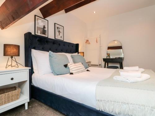 a bedroom with two beds and a table and a chair at Razorbill in Bridlington