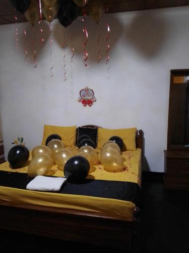 a bed with a bunch of balloons on it at Desandu Walawwa Resort in Kurunegala