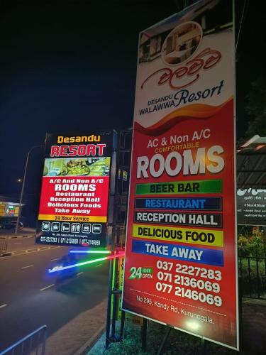 a group of signs on the side of a street at Desandu Walawwa Resort in Kurunegala