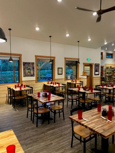 a dining room with wooden tables and chairs at McKinley Creekside Cabins in McKinley Park
