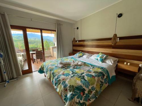 a bedroom with a bed with a wooden head board at Mercedes Lodge in San Ramón
