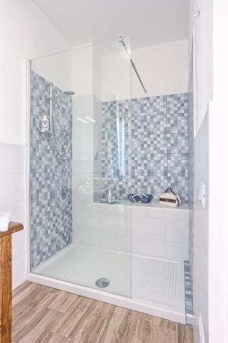 a shower with a glass door in a bathroom at LANTERNA DEL DELTA Guest House in Porto Tolle