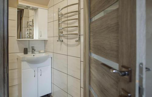 a white bathroom with a sink and a shower at Апарт-готель Уляна in Skhidnitsa