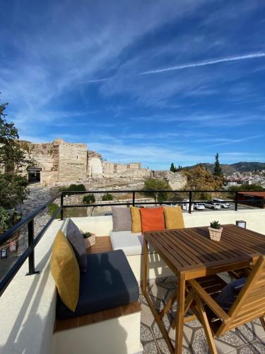 a balcony with a table and chairs and a view at Kallinos Boutique Hotel in Selçuk