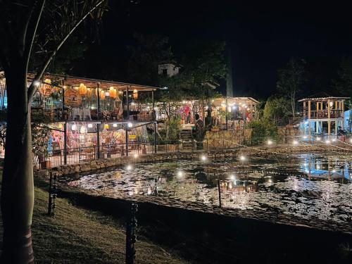 a lit up pond in front of a building at night at Hotel Casa Cantabria Campestre in Villa de Leyva