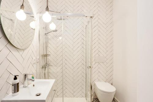 La salle de bains est pourvue d'une douche, d'un lavabo et de toilettes. dans l'établissement Hopstays Oporto Vibes - City Center Studio, à Porto