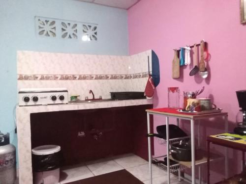a kitchen with a sink and a stove top oven at Beautiful villa for singles, couples, families and groups cozy stay in La Chorrera