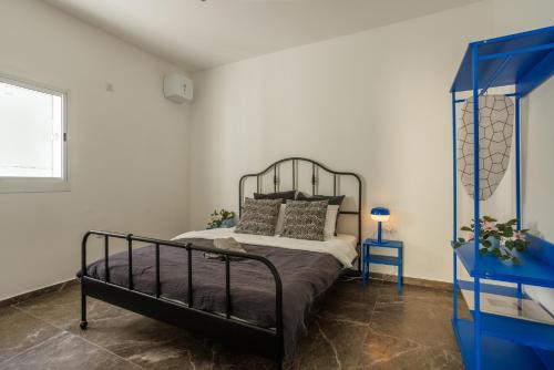 a bedroom with a bed and a blue dresser at Lapin Premium With Balcony By Nimizz in Tel Aviv