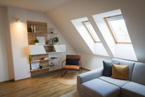 a living room with a couch and a window at Maisonette Apartment with Terrace in Koliba