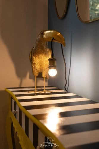 a statue of a bird sitting on top of a crib at LA CASA DI ZOE in Manfredonia