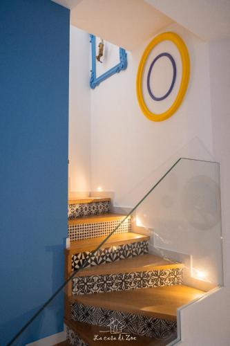 a set of stairs with a yellow circle on the wall at LA CASA DI ZOE in Manfredonia