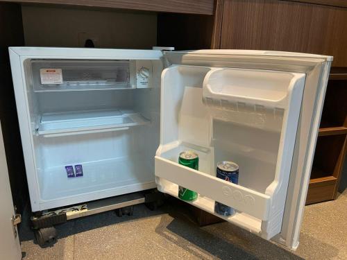 an empty refrigerator with its door open in a room at Coco Palms Resort, Diveagar in Diveagar