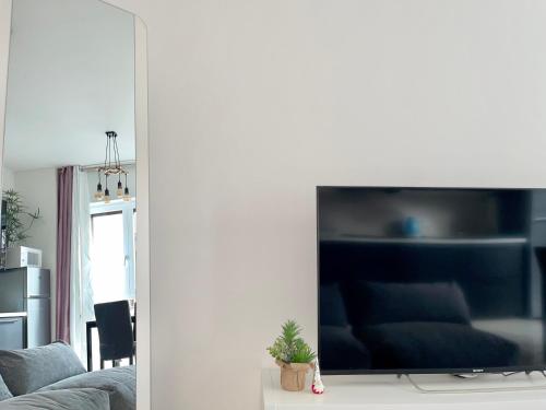 a living room with a large flat screen tv at THE WHITE HOUSE, Modern apartment in Center in Milan