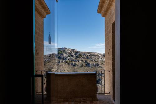 a view of a mountain through a window at BV Quarry Matera in Matera