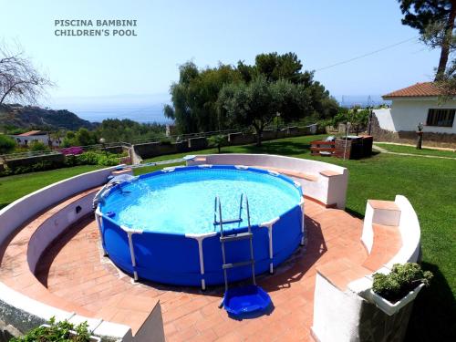 a large swimming pool in a yard at Villa Eulalia in Capo Vaticano
