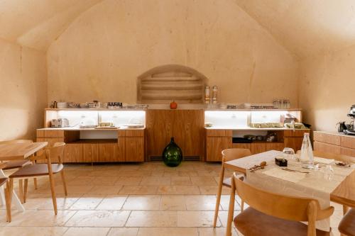 a kitchen with a table and chairs in a room at BV Quarry Matera in Matera