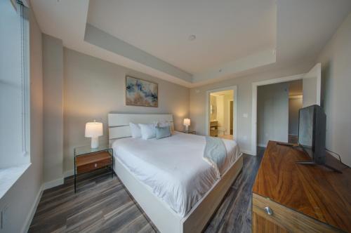a bedroom with a bed and a flat screen tv at Moderno in Fort Lauderdale