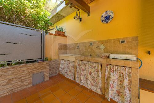 a kitchen with a large screen on the wall at Villino Aloe - Goelba in Marina di Campo