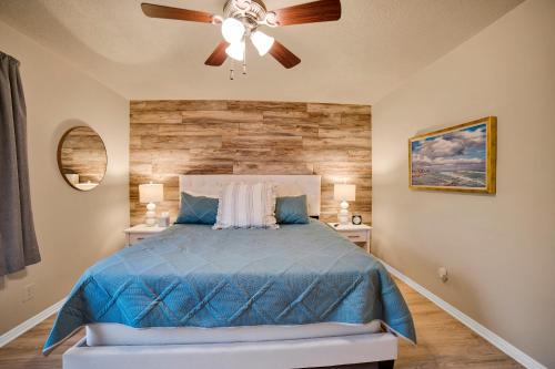 a bedroom with a blue bed with a ceiling fan at Mesquite 2BR Townhome with Pool & Gym Access in Mesquite