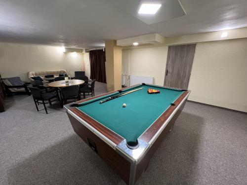 a room with a pool table in a room with chairs at Pension Fortuna in Halenkov