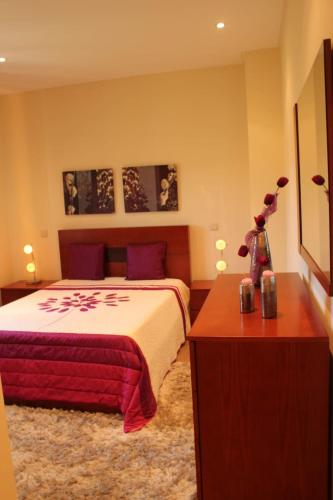 a bedroom with a bed and a table with flowers on it at Villa 315 in Laundos