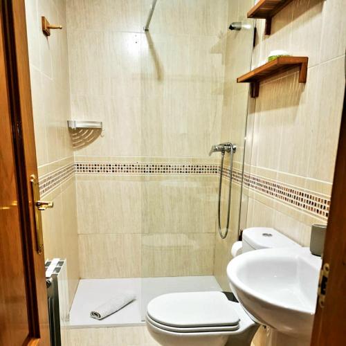 a bathroom with a toilet and a sink at ZUBICALM in La Zubia