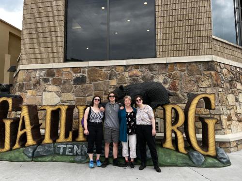a group of people standing in front of a sign at Comfy Condo With Amazing View of Gatlinburg and the Smokies in Gatlinburg