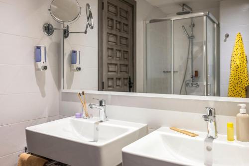 a bathroom with two sinks and a large mirror at TUI MAGIC LIFE Cala Pada - All Inclusive in Santa Eularia des Riu