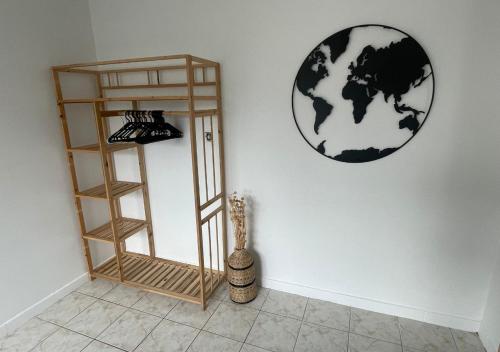 a room with a shelf and a globe on the wall at Appartement avec petit jardin in Bagnères-de-Bigorre