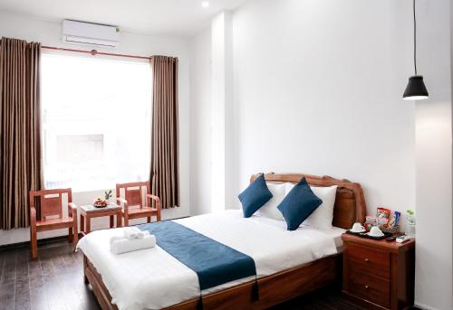 a bedroom with a bed and a large window at La Cactus Hotel 1 in Quy Nhon