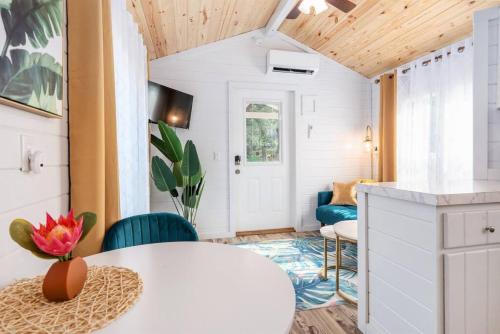 a tiny house with a white table and chairs at 7 Le Soleil Retro Tiny House, Boat Parking, Mins to Lake Guntersville, City Harbor in Guntersville