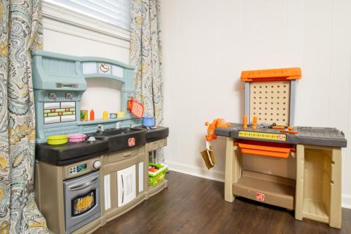 a play room with a kitchen and a play table at Home Away in Taylors by Brick and Home in Taylors