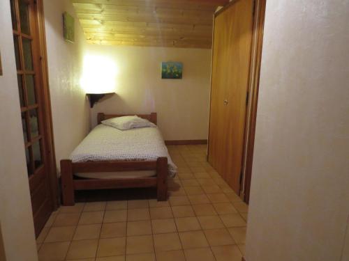 a small bedroom with a bed in a room at Studio cosy au Grand-Bornand avec balcon, animaux et parking - FR-1-467-72 in Le Grand-Bornand