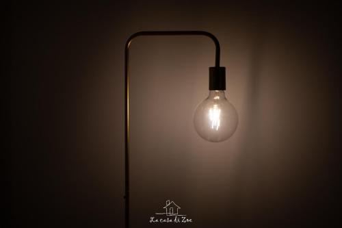 a light bulb is hanging on a wall at LA CASA DI ZOE in Manfredonia