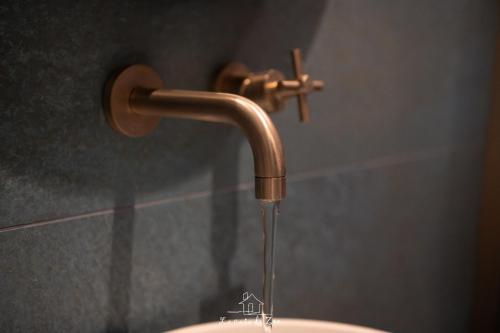 a bathroom sink with a copper water faucet at LA CASA DI ZOE in Manfredonia