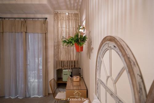 a dining room with a table and a plant on the wall at LA CASA DI ZOE in Manfredonia