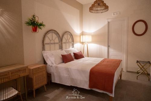 a bedroom with a bed and a table and a lamp at LA CASA DI ZOE in Manfredonia